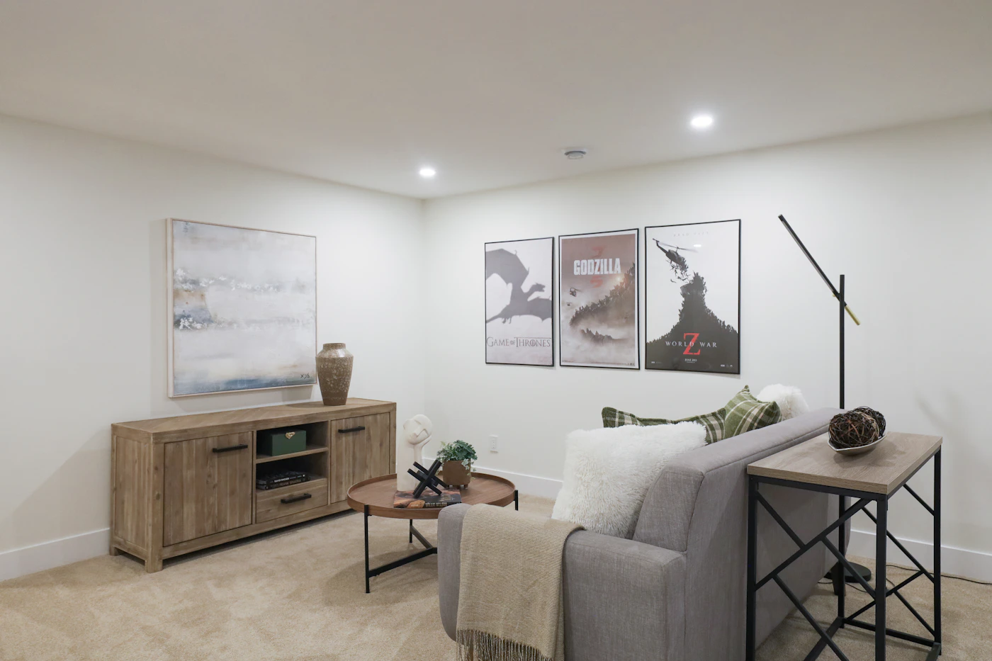 Finished basement living room with sofa and movie posters
