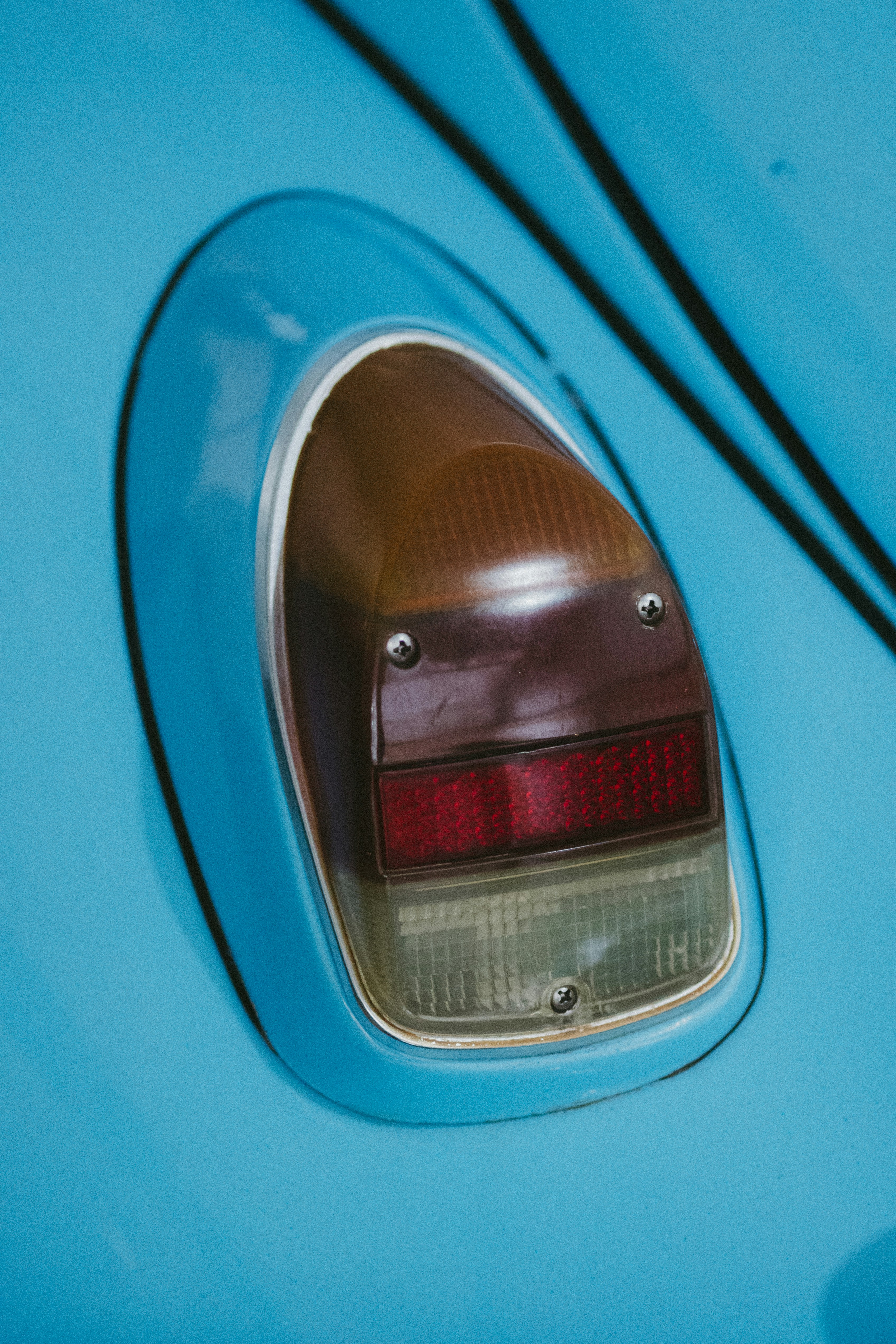 Close-up of a vintage car's blue tail light