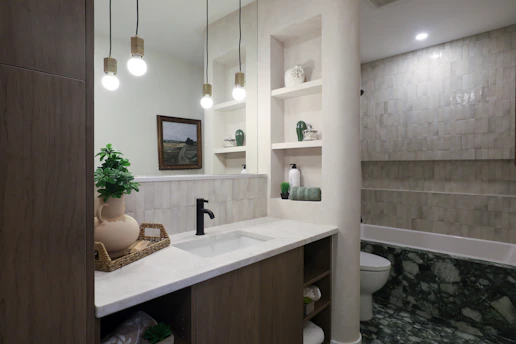 Modern bathroom with a sink and bathtub.