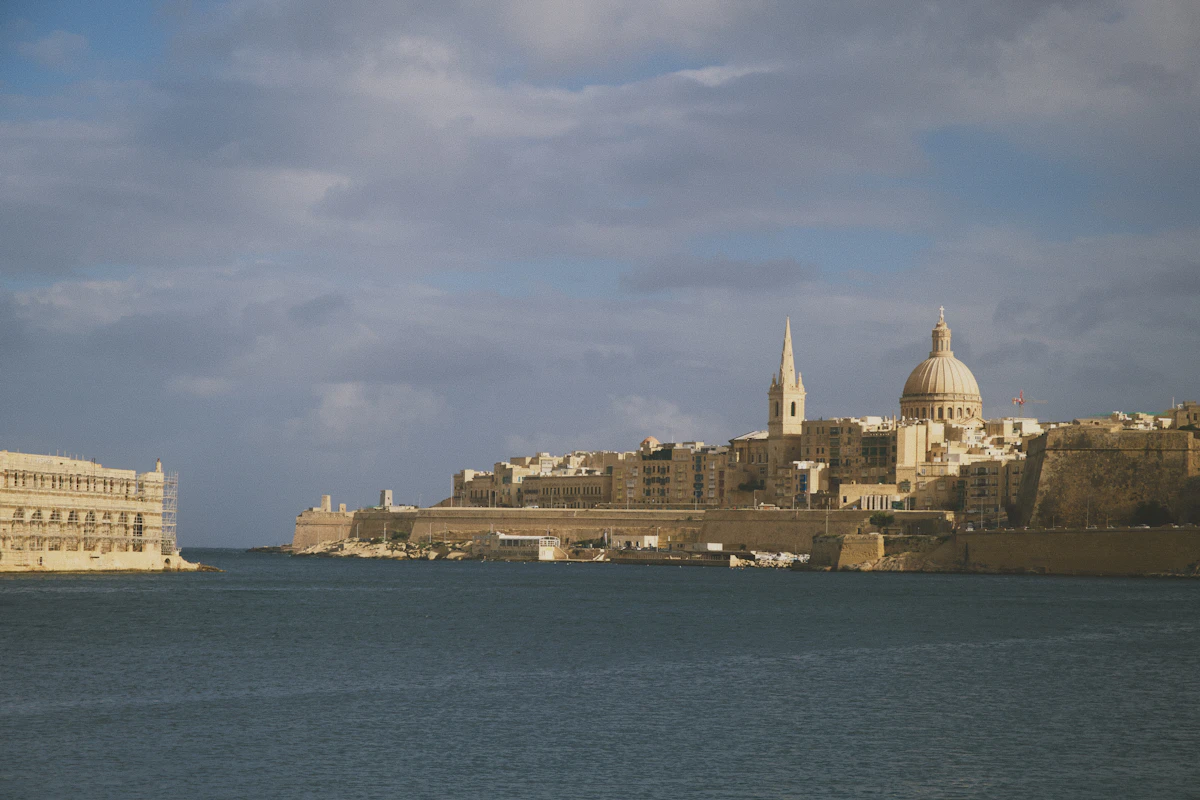 Valletta's fortified skyline, cathedral dome and spire seen across the harbour