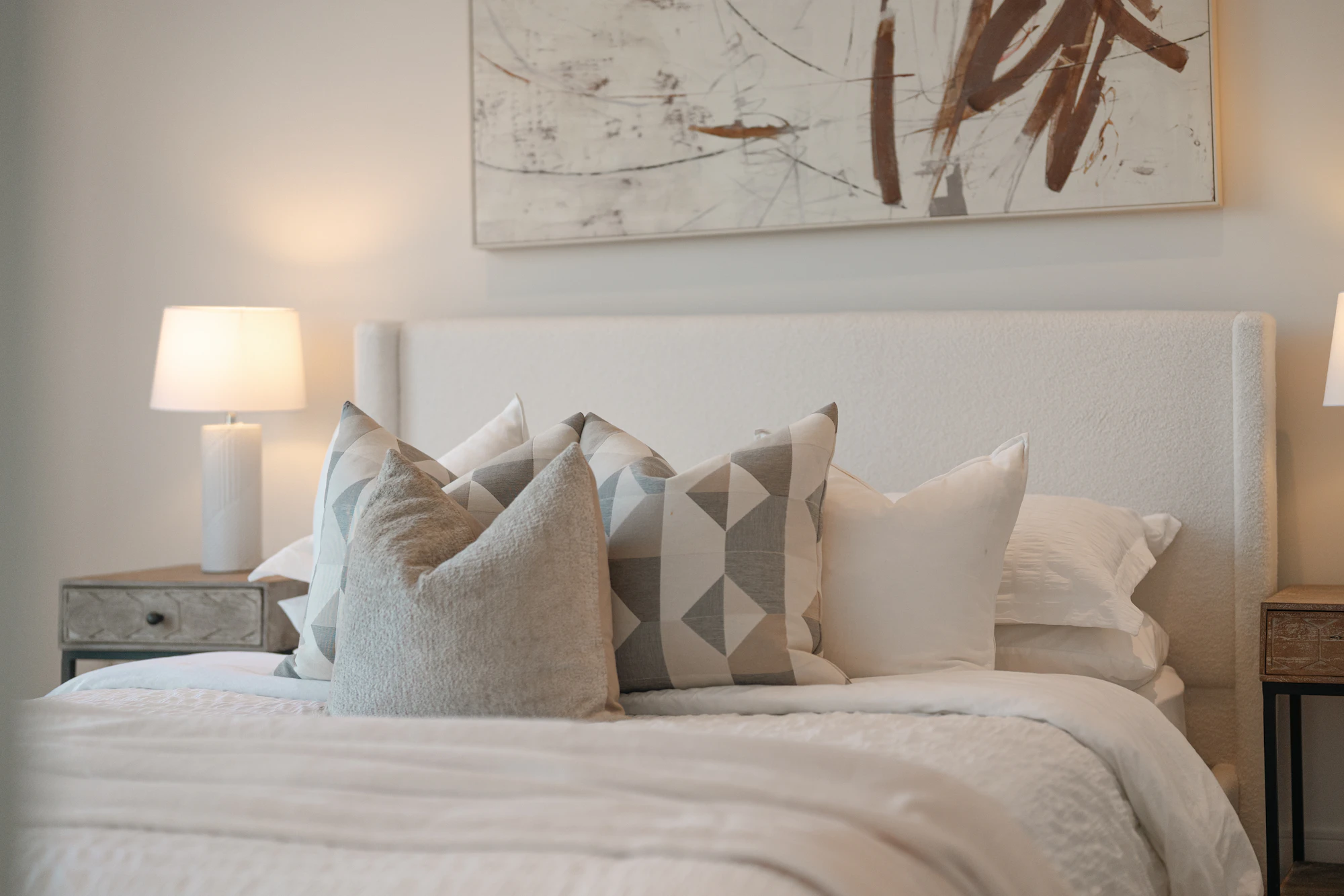 Bedroom with decorative pillows and artwork