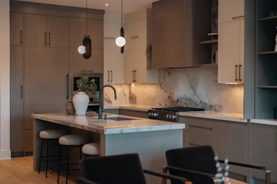 Modern kitchen with island and marble backsplash