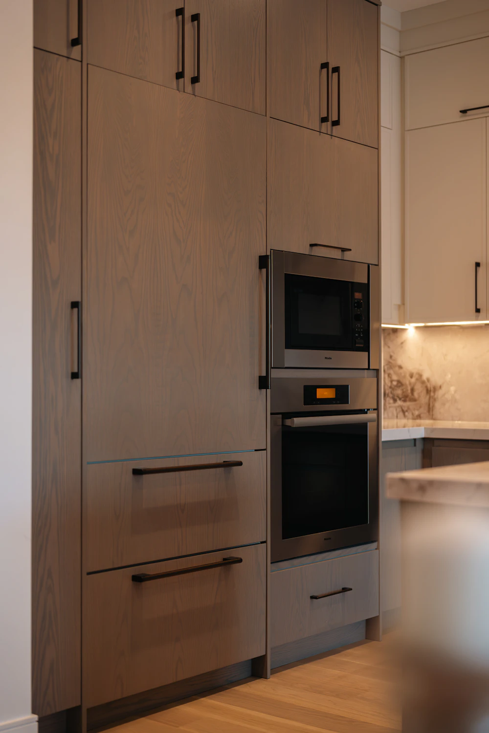 Kitchen cabinetry with built-in oven and microwave, shown as appliance integration inspiration
