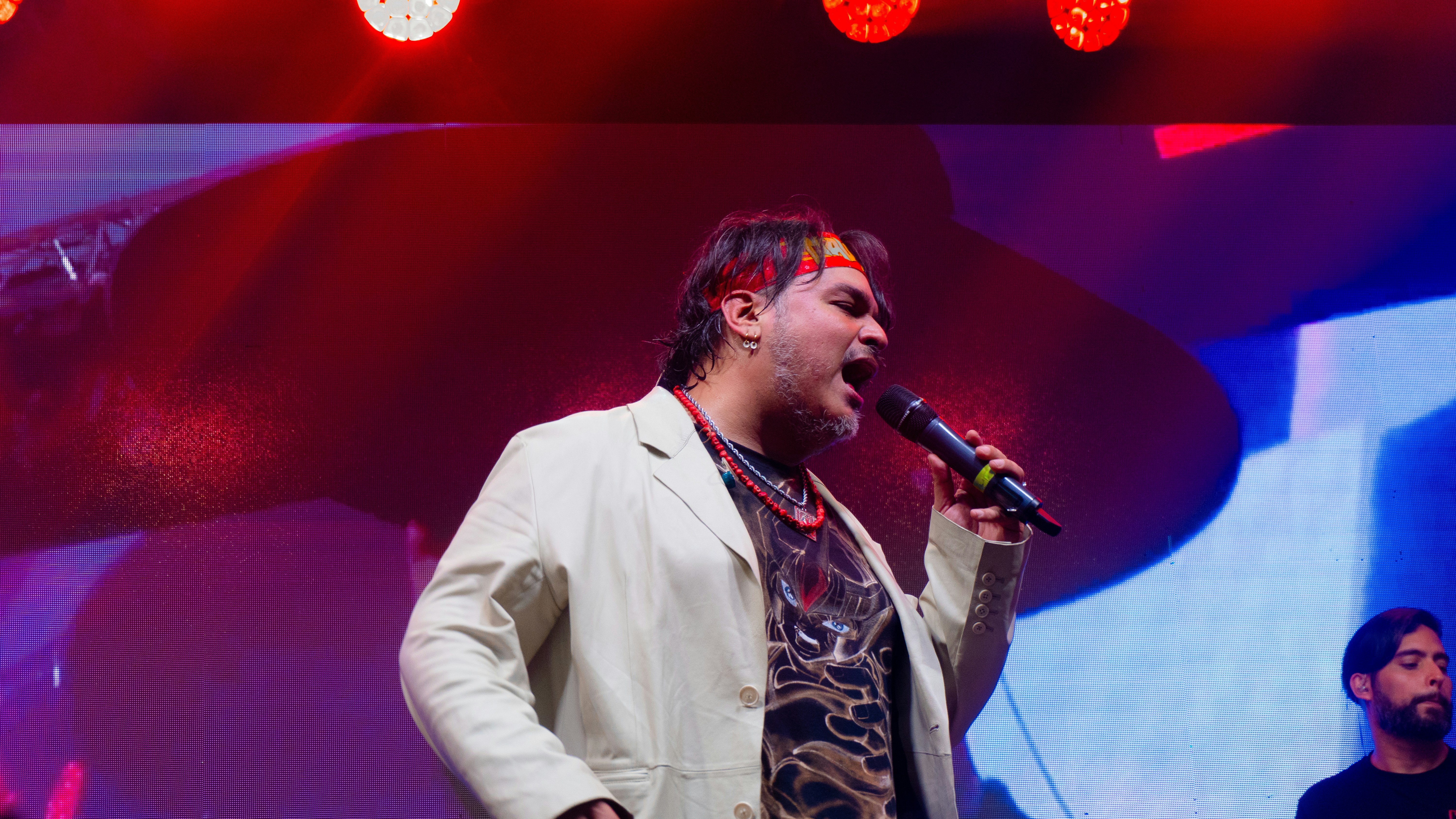 Man singing into a microphone on stage