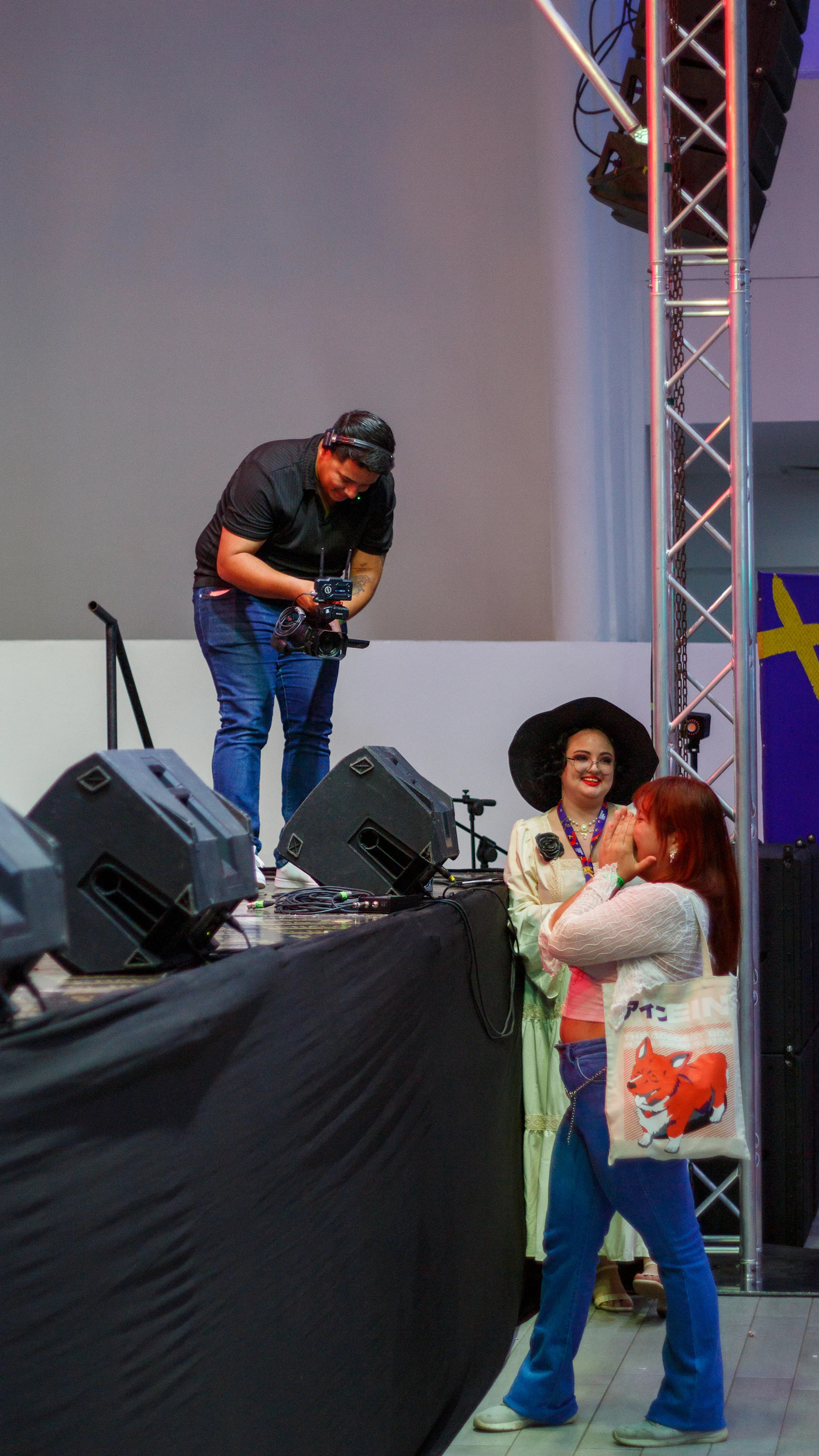 Camera operator filming a live worship event with an LED screen