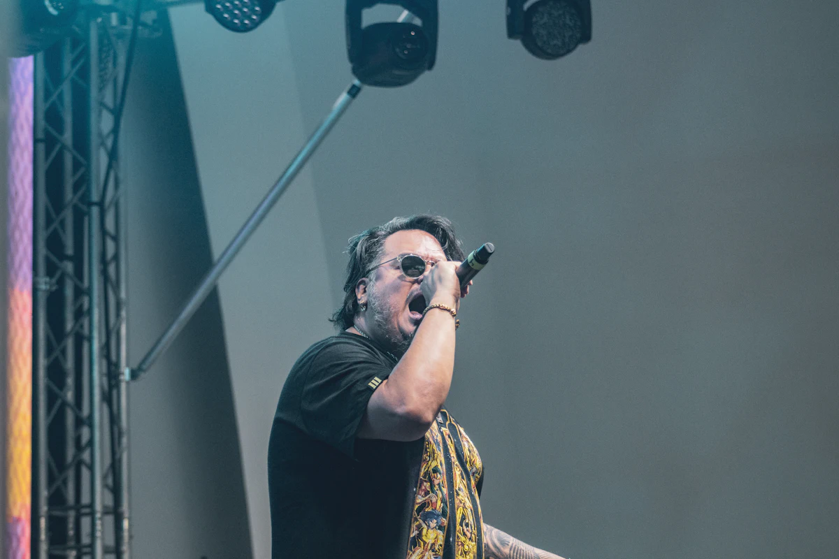 Singer performing into a microphone on stage