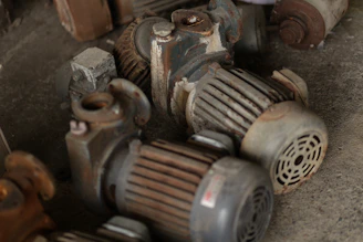 Several old electric motors piled together