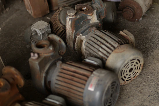 Several old electric motors piled together