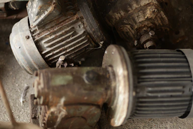 Three old rusty electric motors piled together