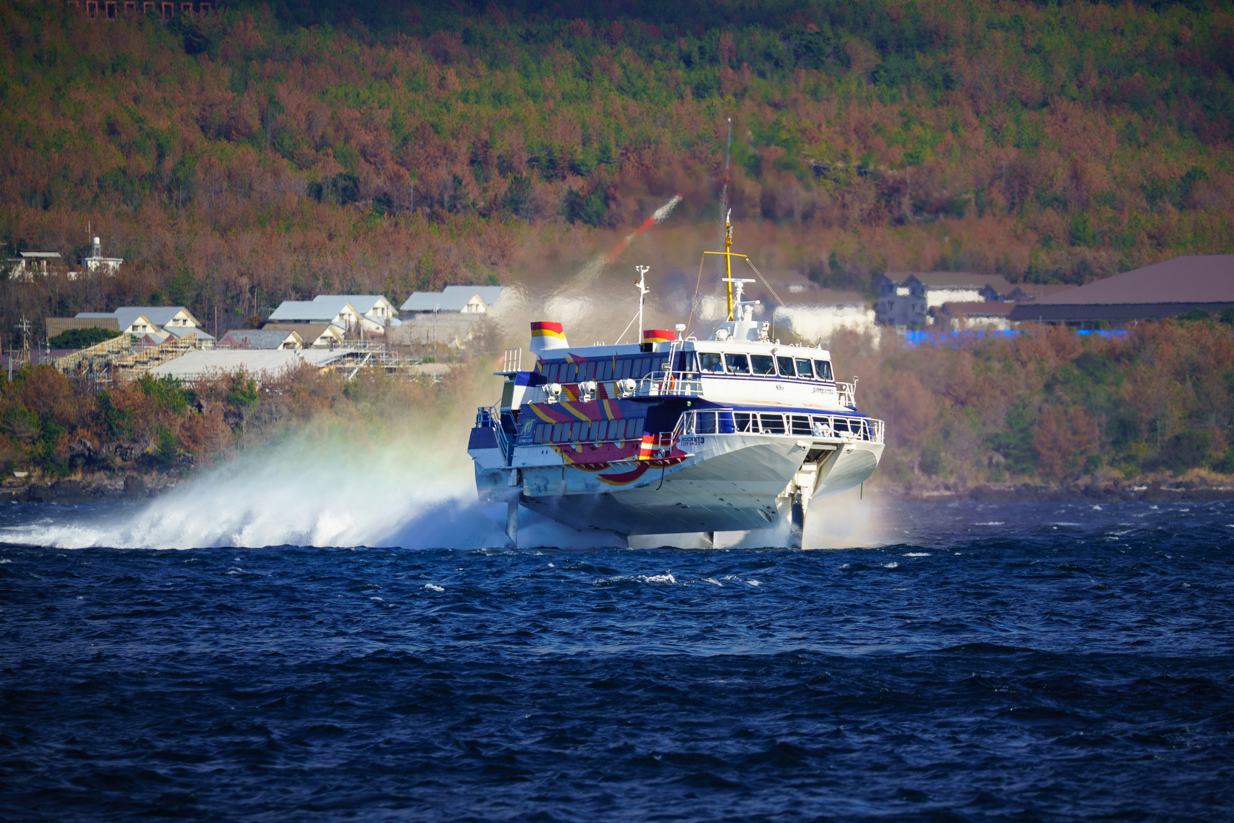 A fast passenger ferry speeding through the water