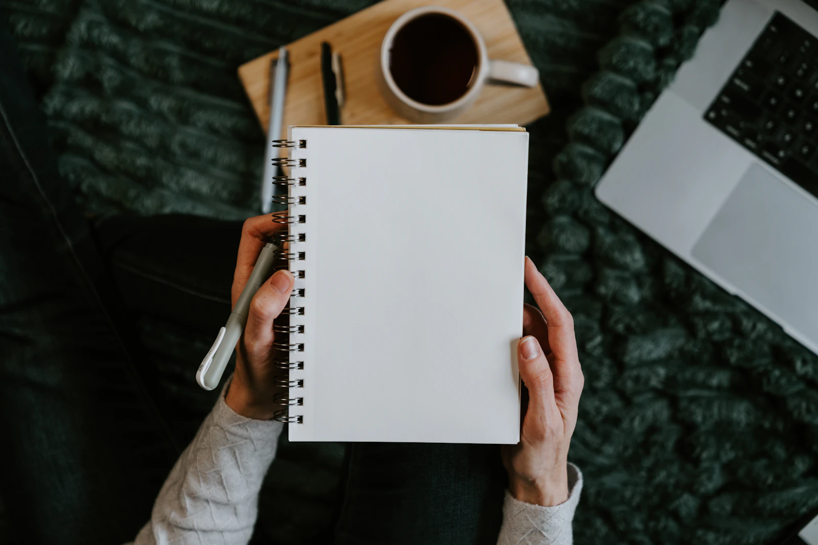 Notebook and laptop used to plan and revise email copy