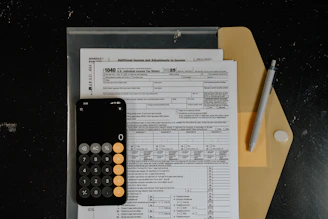 Calculator and pen on tax forms