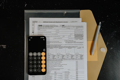 Calculator and pen on tax forms