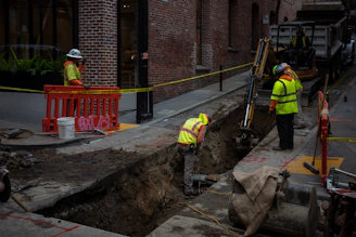 Construction workers digging a trench on a city street