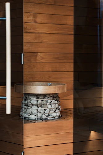 Sauna heater stones with warm wooden interior