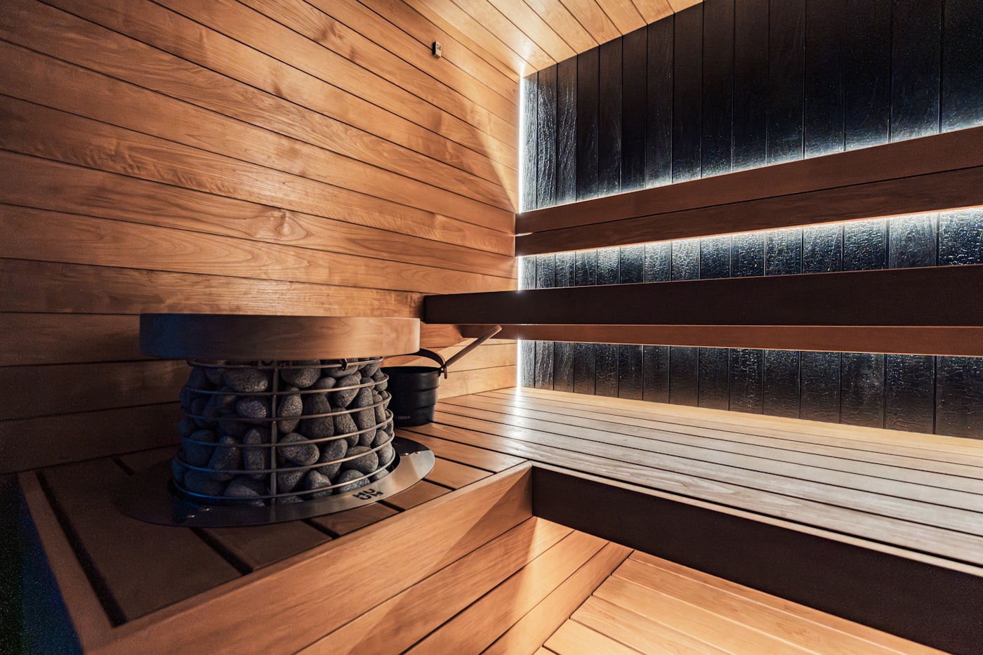 A peaceful home sauna with warm cedar interior and ambient lighting