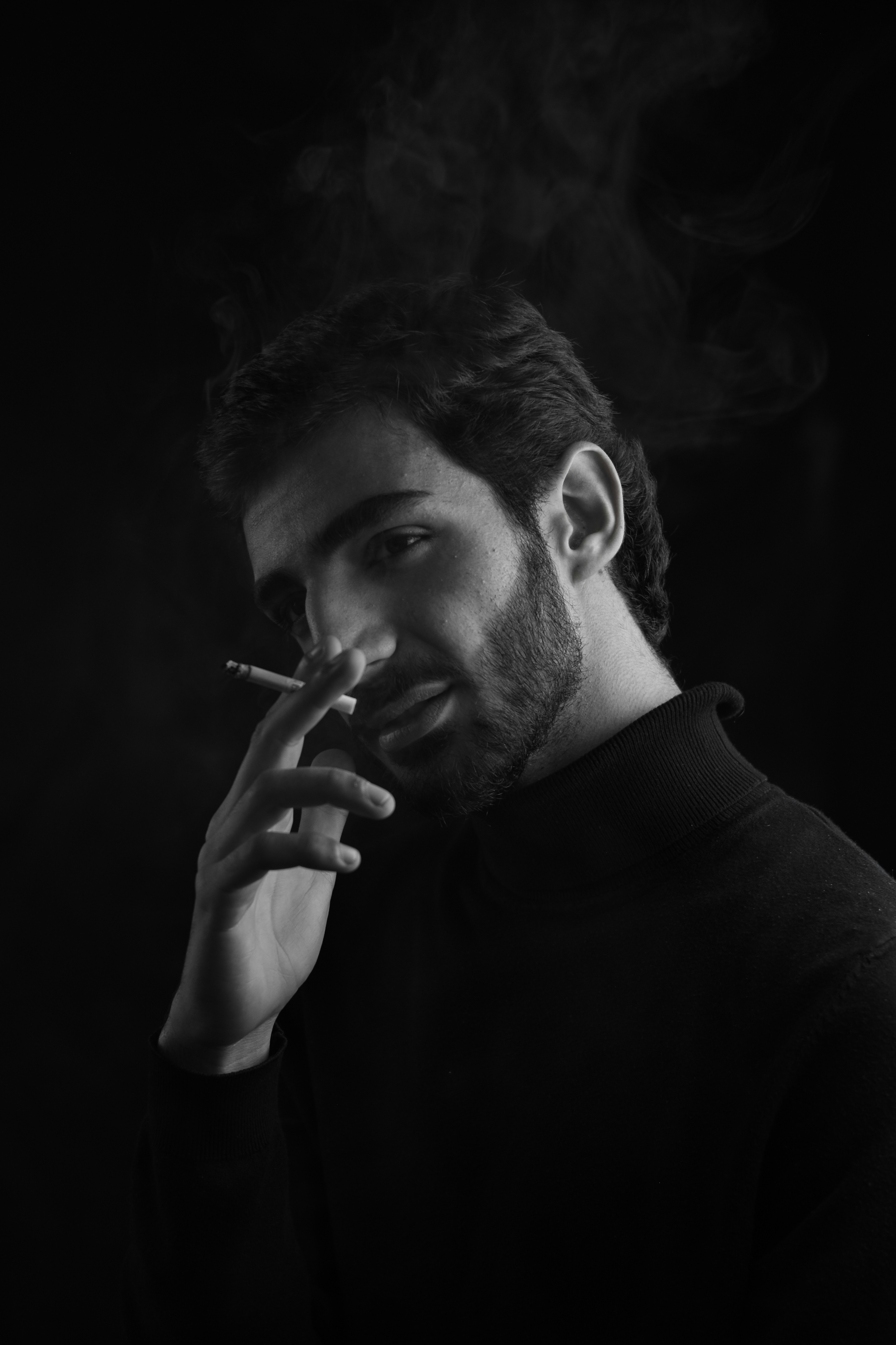 Man smoking a cigarette with smoke rising