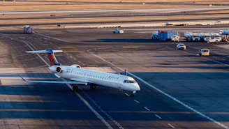 A commercial airplane taxis on an airport tarmac.