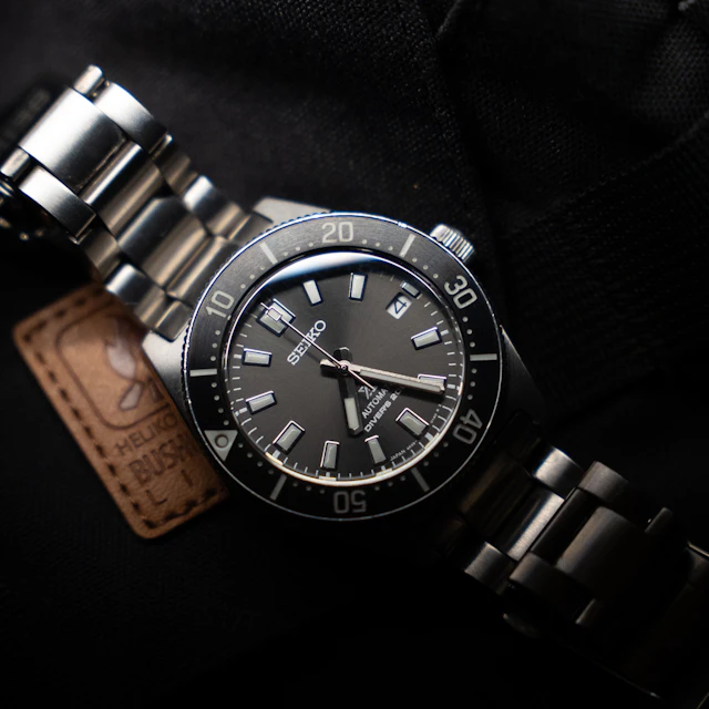 A close-up of a luxury wristwatch on a dark background