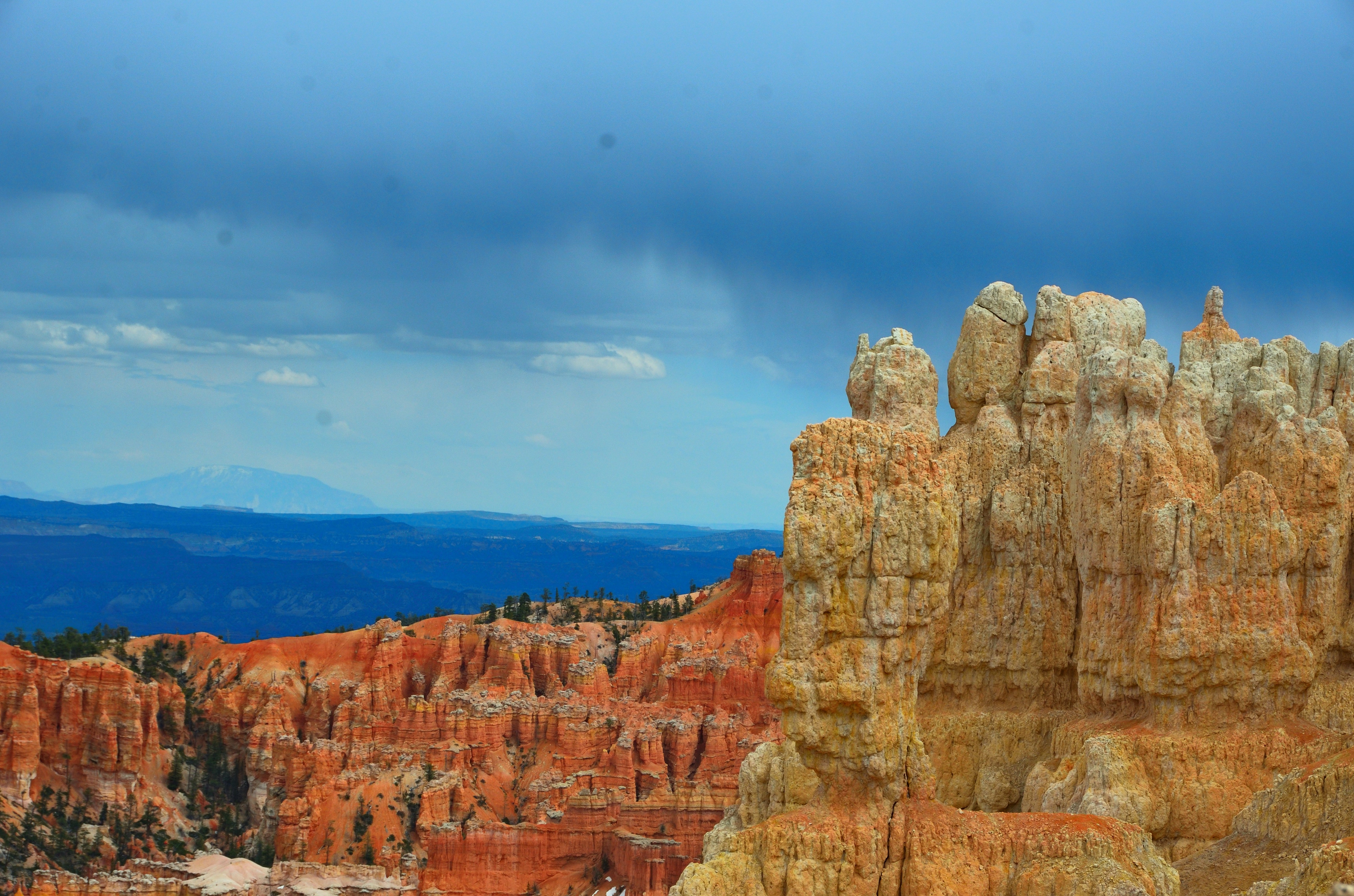 Hoodoos and colorful rock formations under a stormy sky