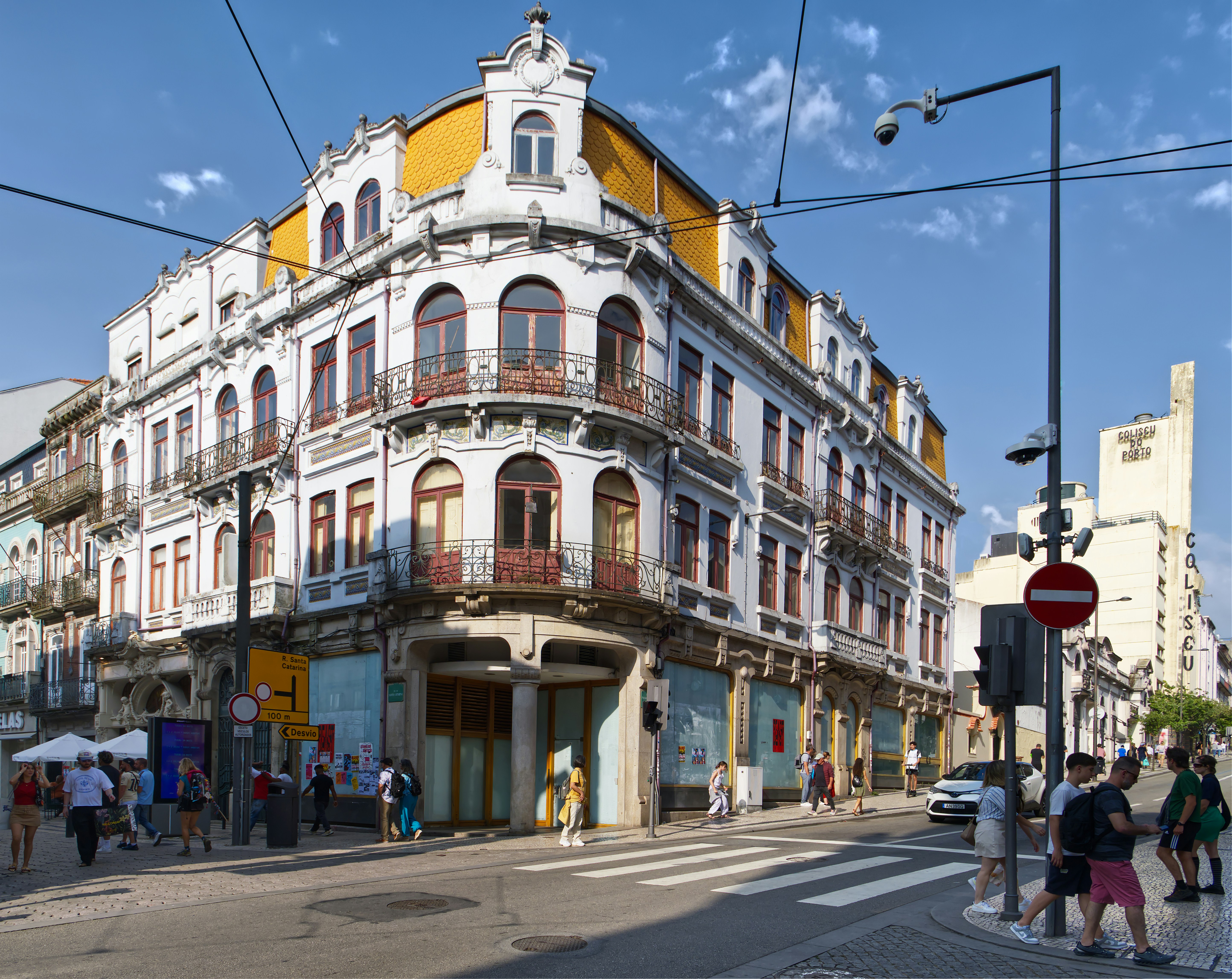 Ornate building on a sunny city street corner.