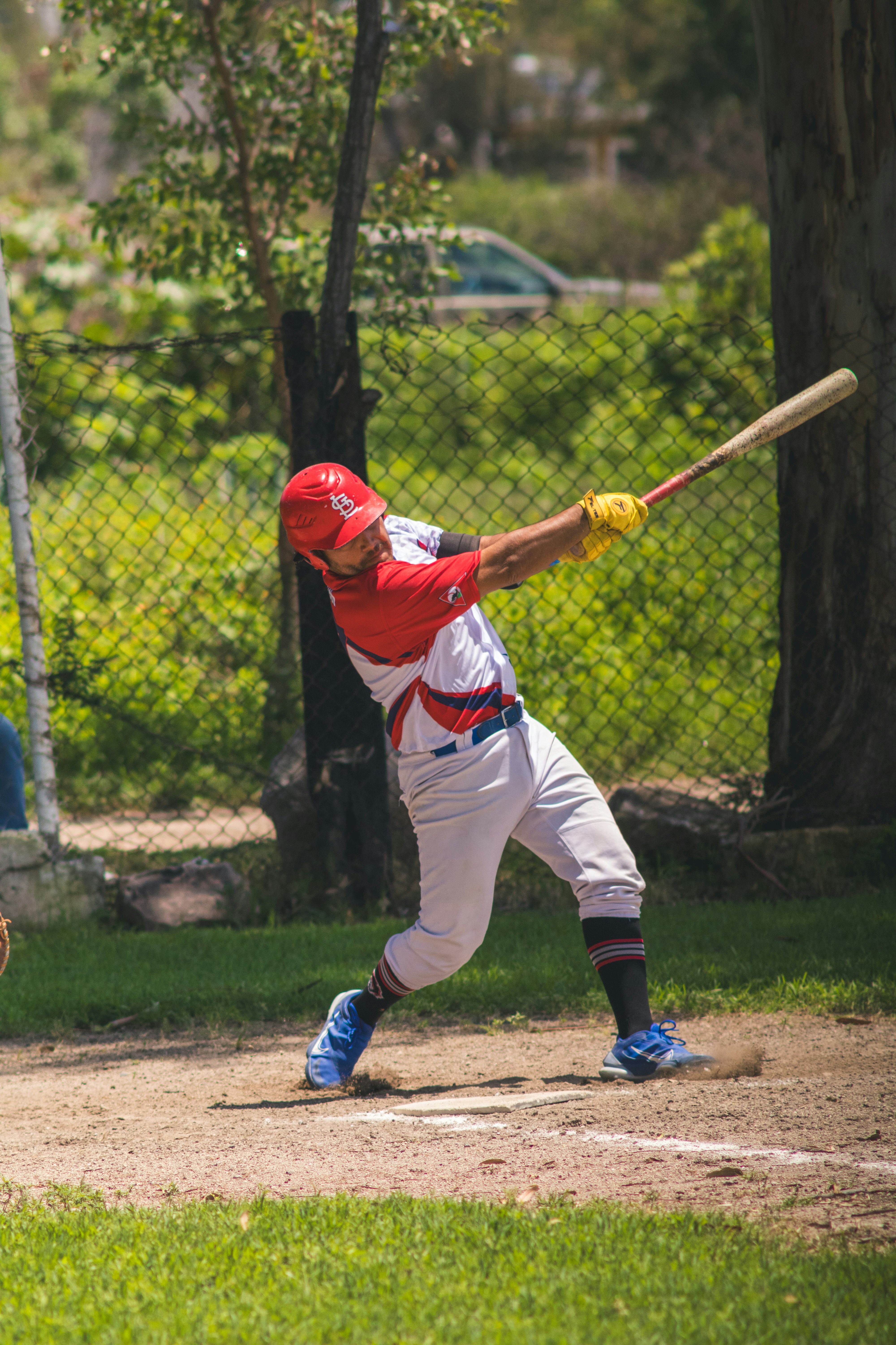 Baseball player swinging bat during game.