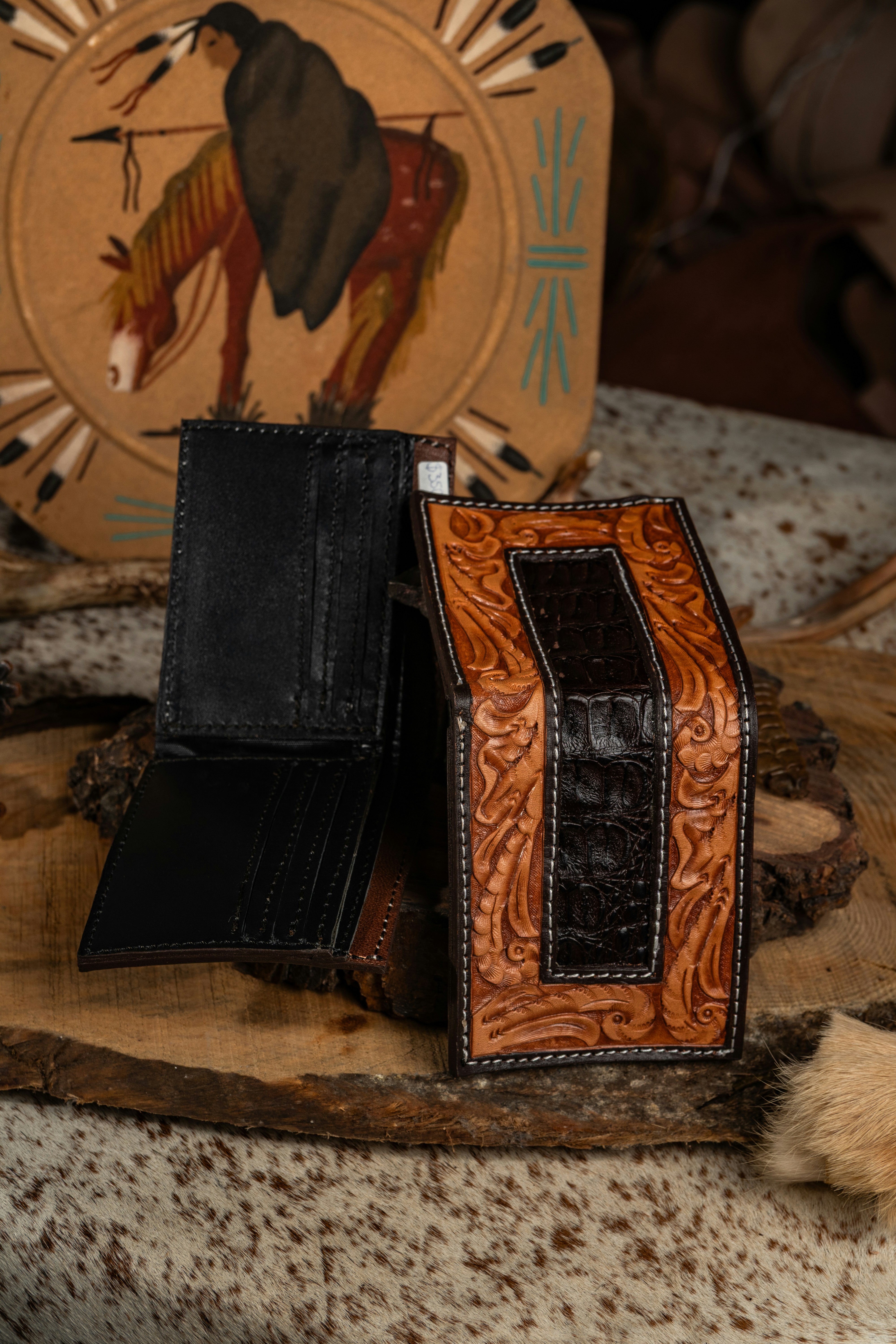 Two leather wallets on a wooden surface
