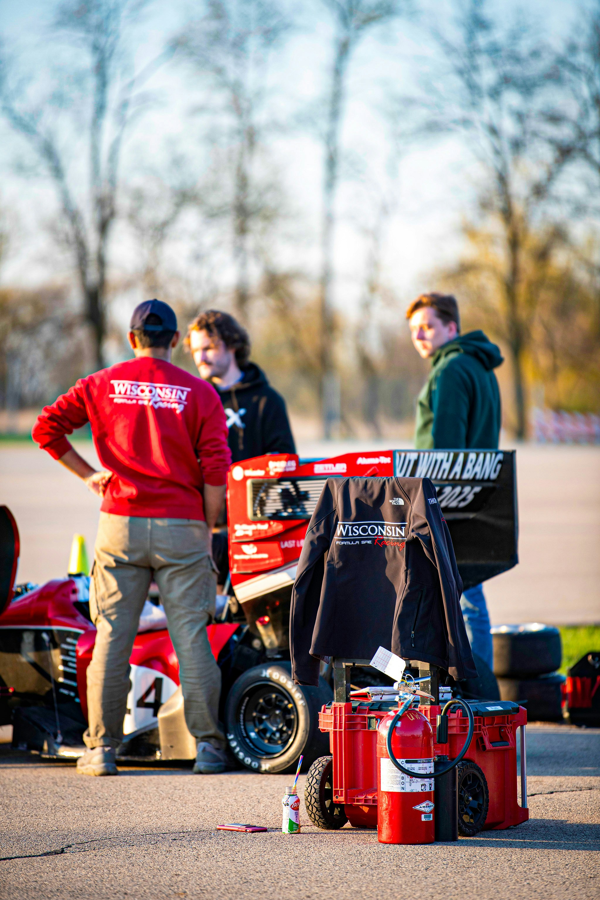 Young men with a racing car and equipment