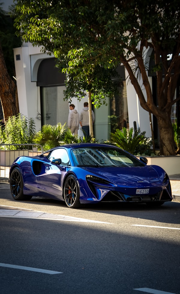 Blue sports car parked on a city street