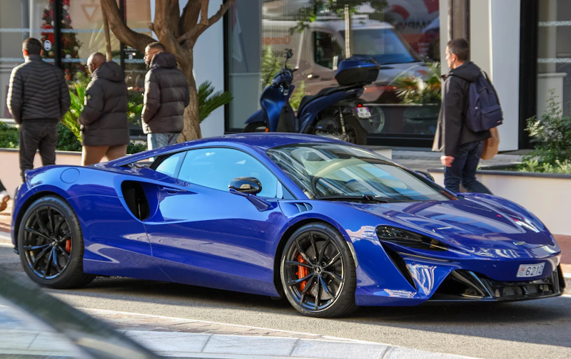 A sleek blue sports car, a sugar baby's dream