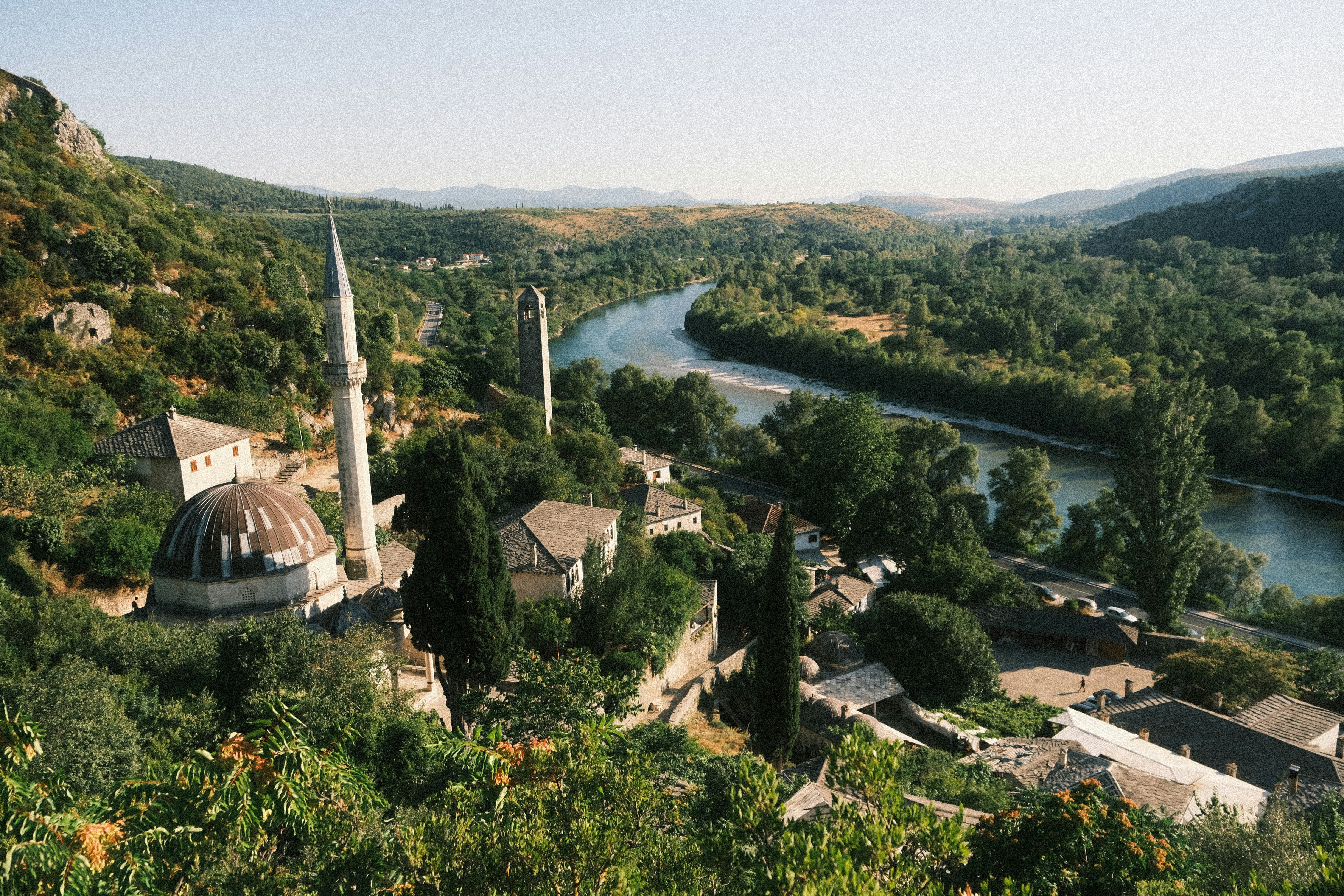 Mosque and village nestled by a winding river valley.