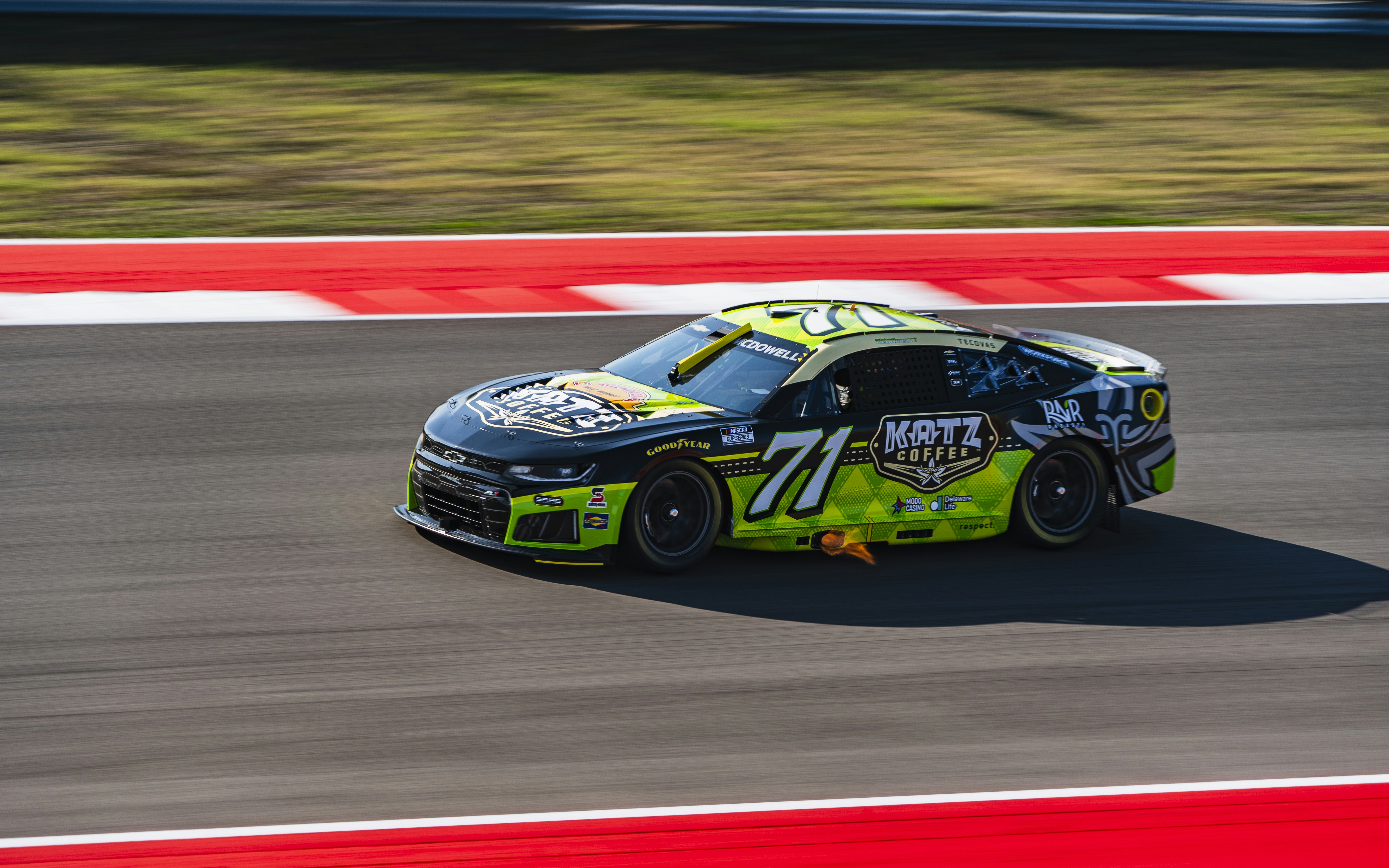 Race car number 71 speeding on a track.