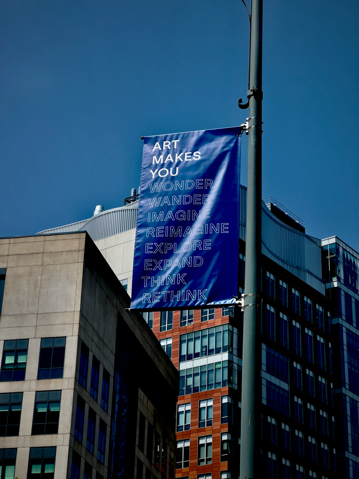 Blue outdoor art banner on a pole