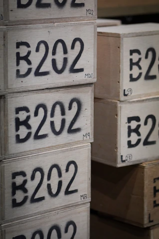 Wooden crates stacked with b202 stenciled on them