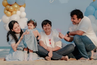 Family celebrating a child's birthday on the beach.
