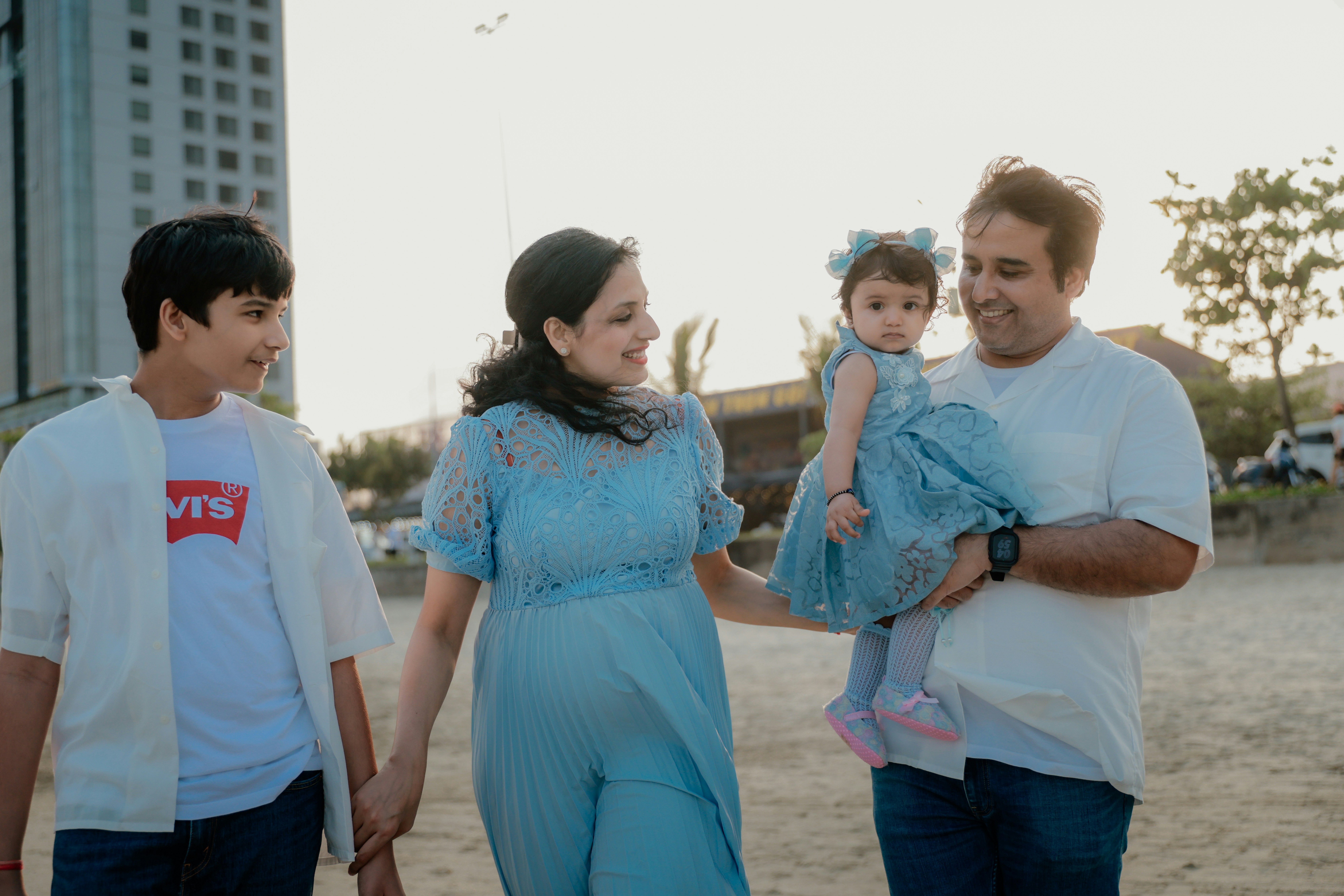Family walking on the beach at sunset