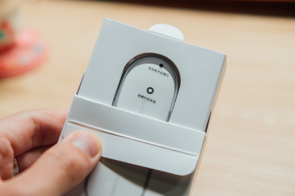 Hands opening a product box to reveal its contents, representing the moment of customer product experience and expectation