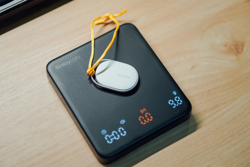 Digital kitchen scale with a white device on a countertop