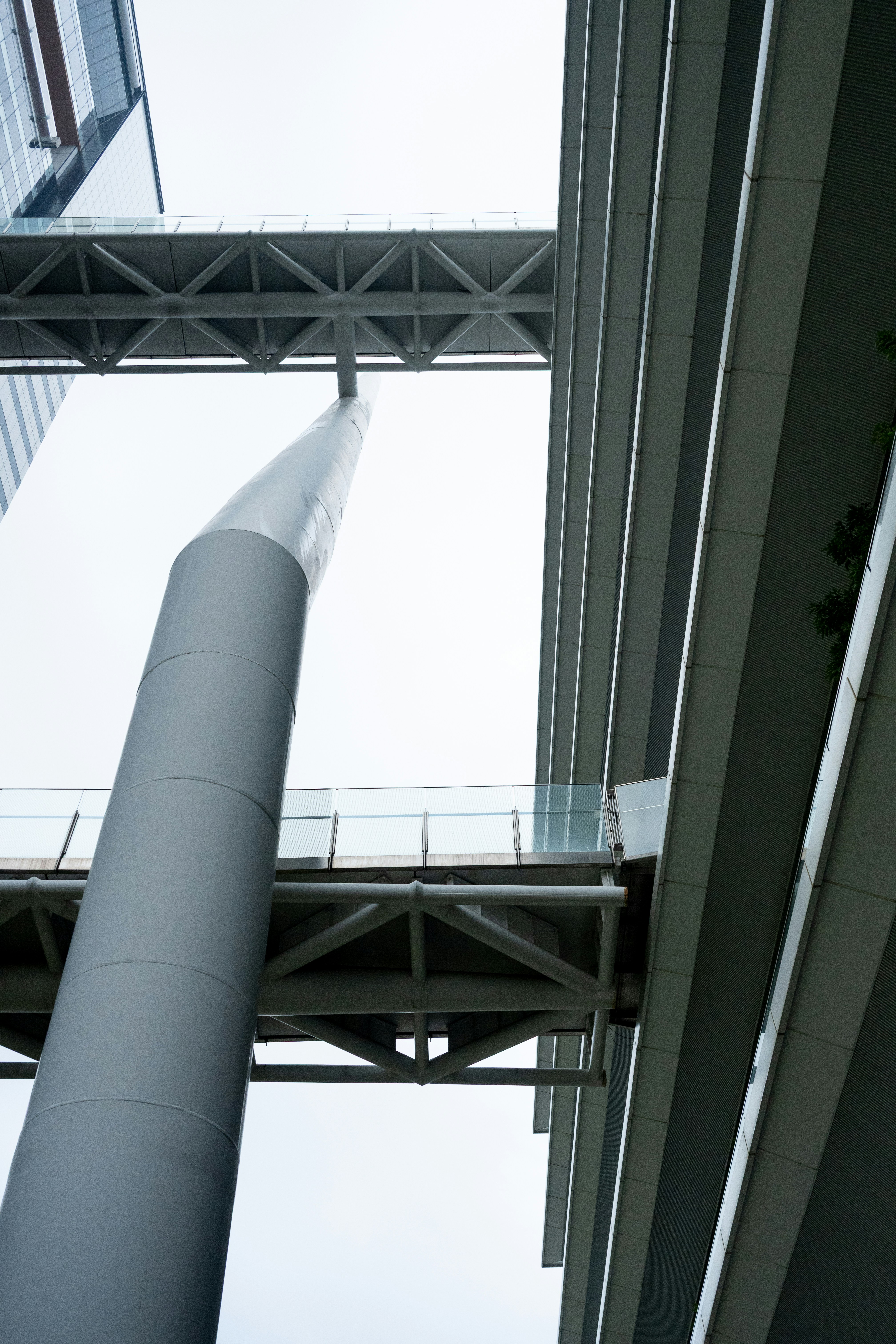 Modern buildings connected by skybridges and a central pillar.