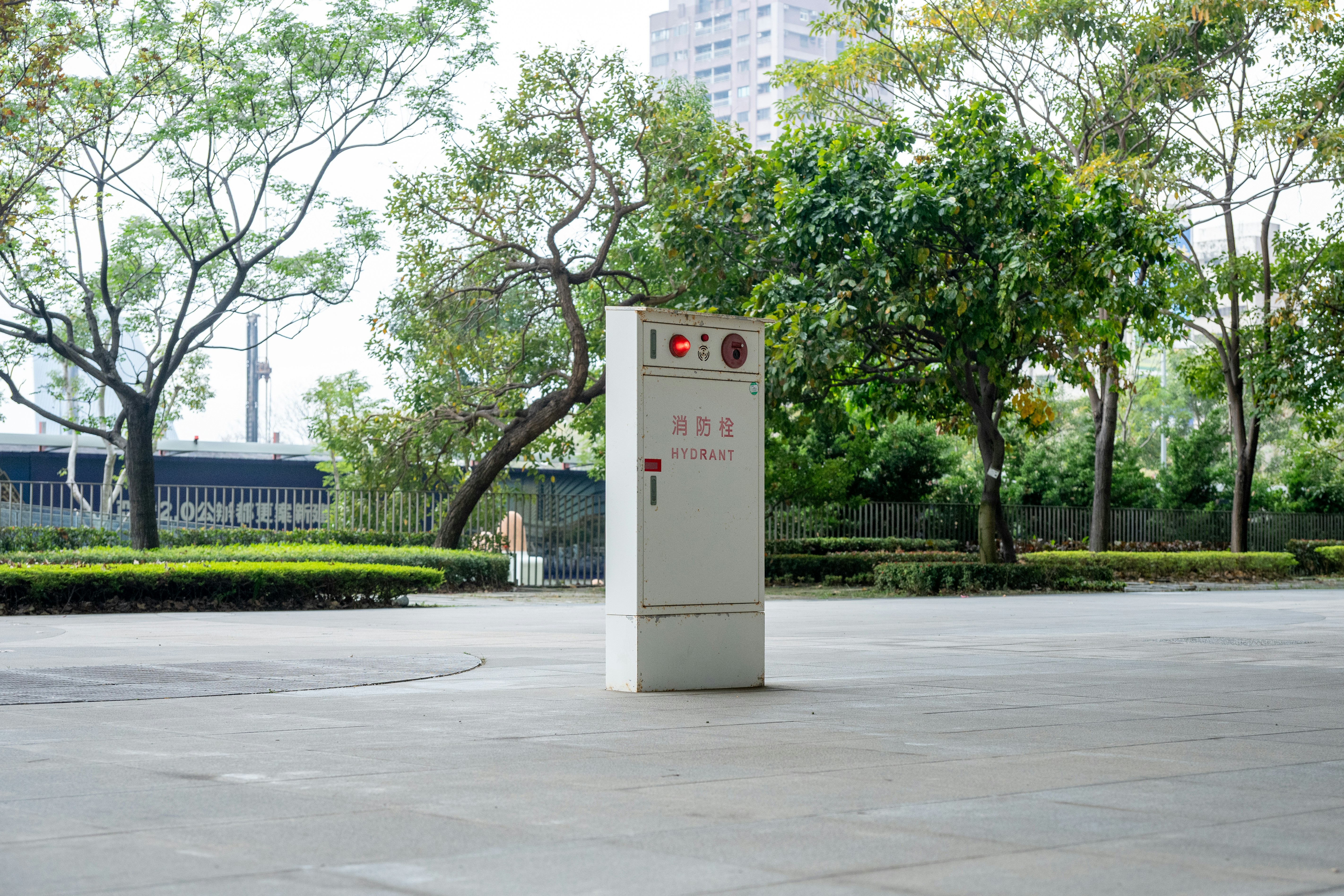 A tall white sign stands in an outdoor plaza.