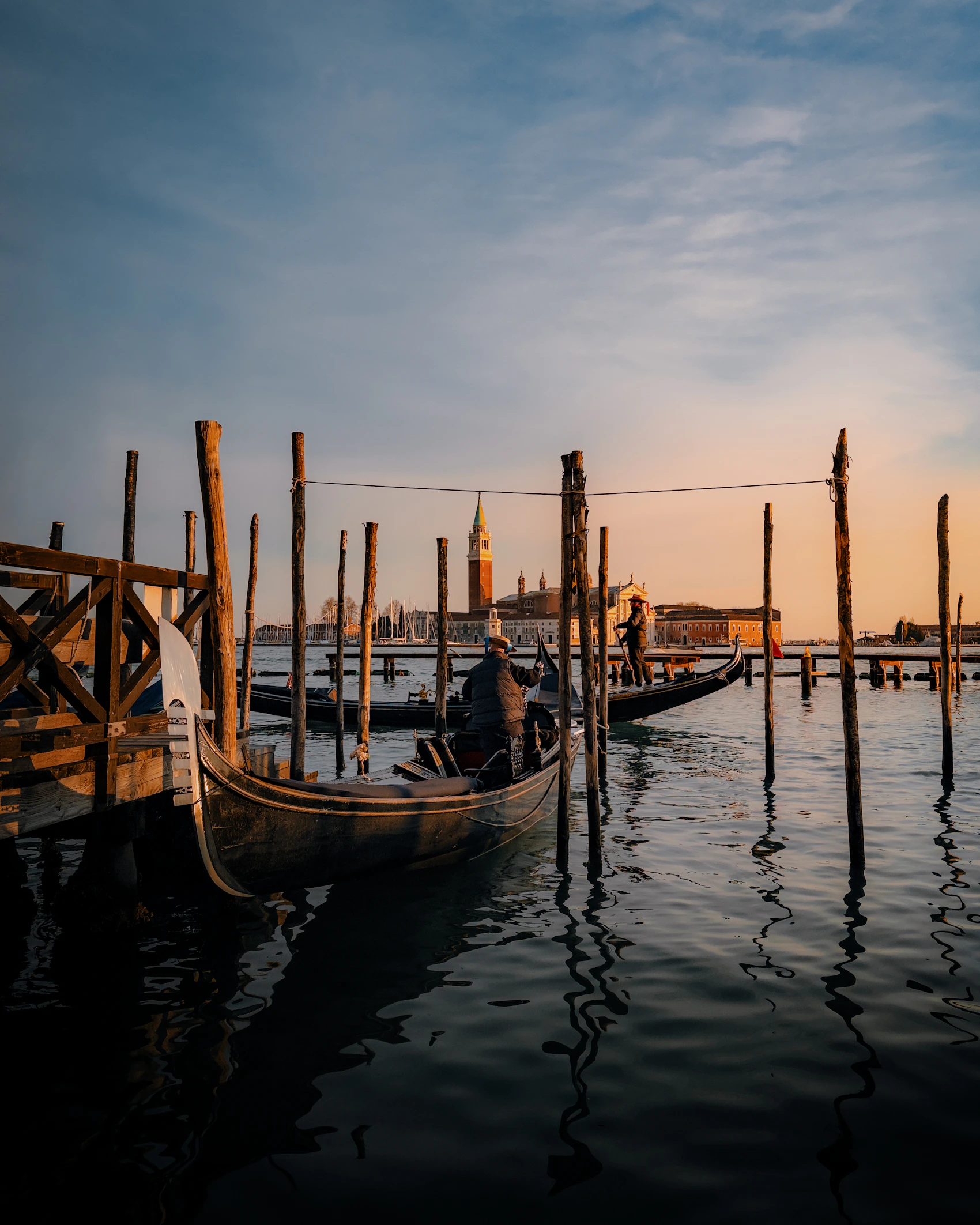 Gondolas moored on the Venetian lagoon as the sun sets