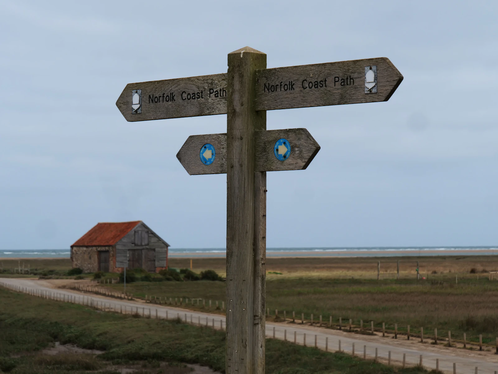 Signpost at the lane end, pointing the usual way