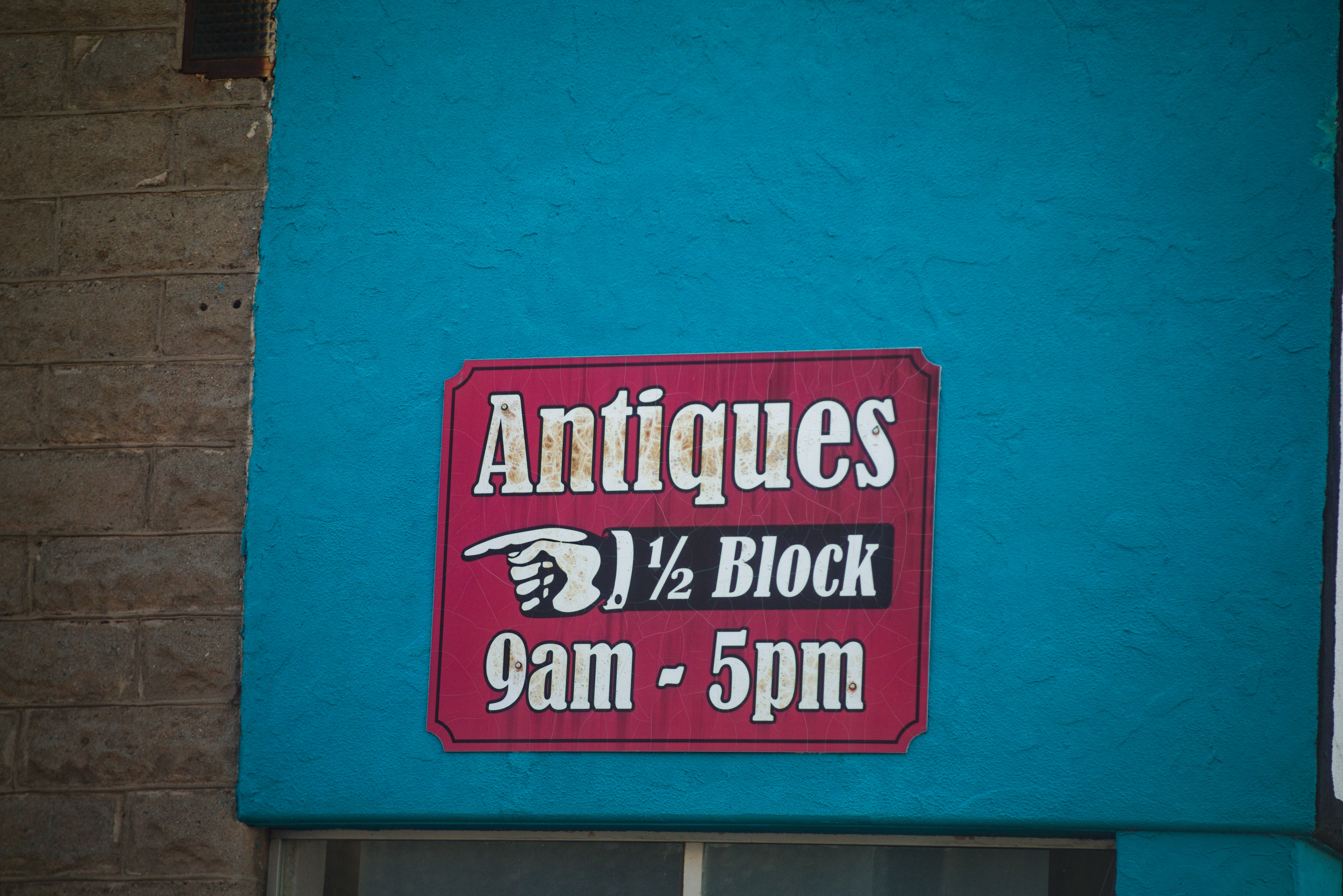 Antiques sign points to half block, 9am to 5pm.