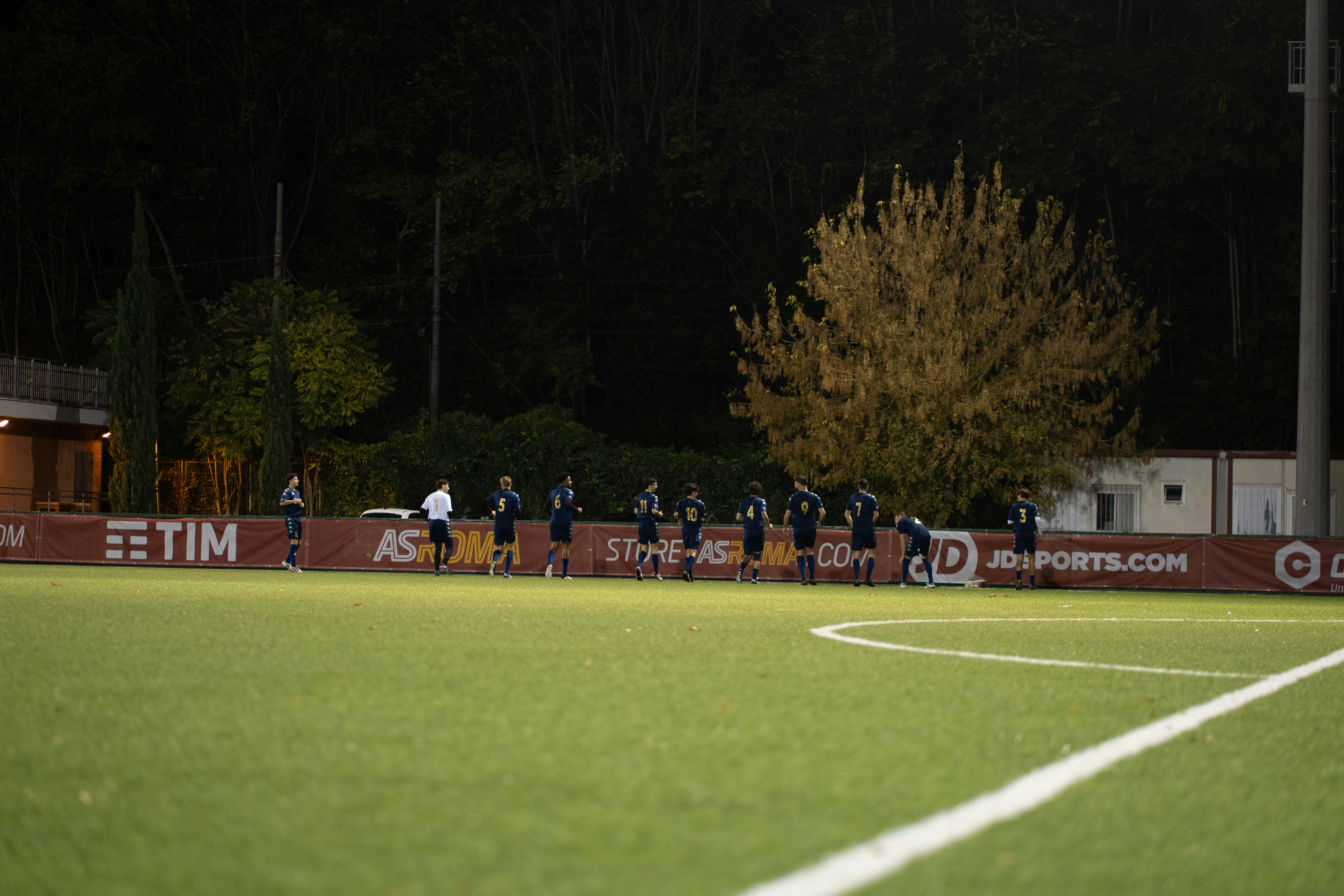 Estadio de fútbol iluminado durante un partido nocturno
