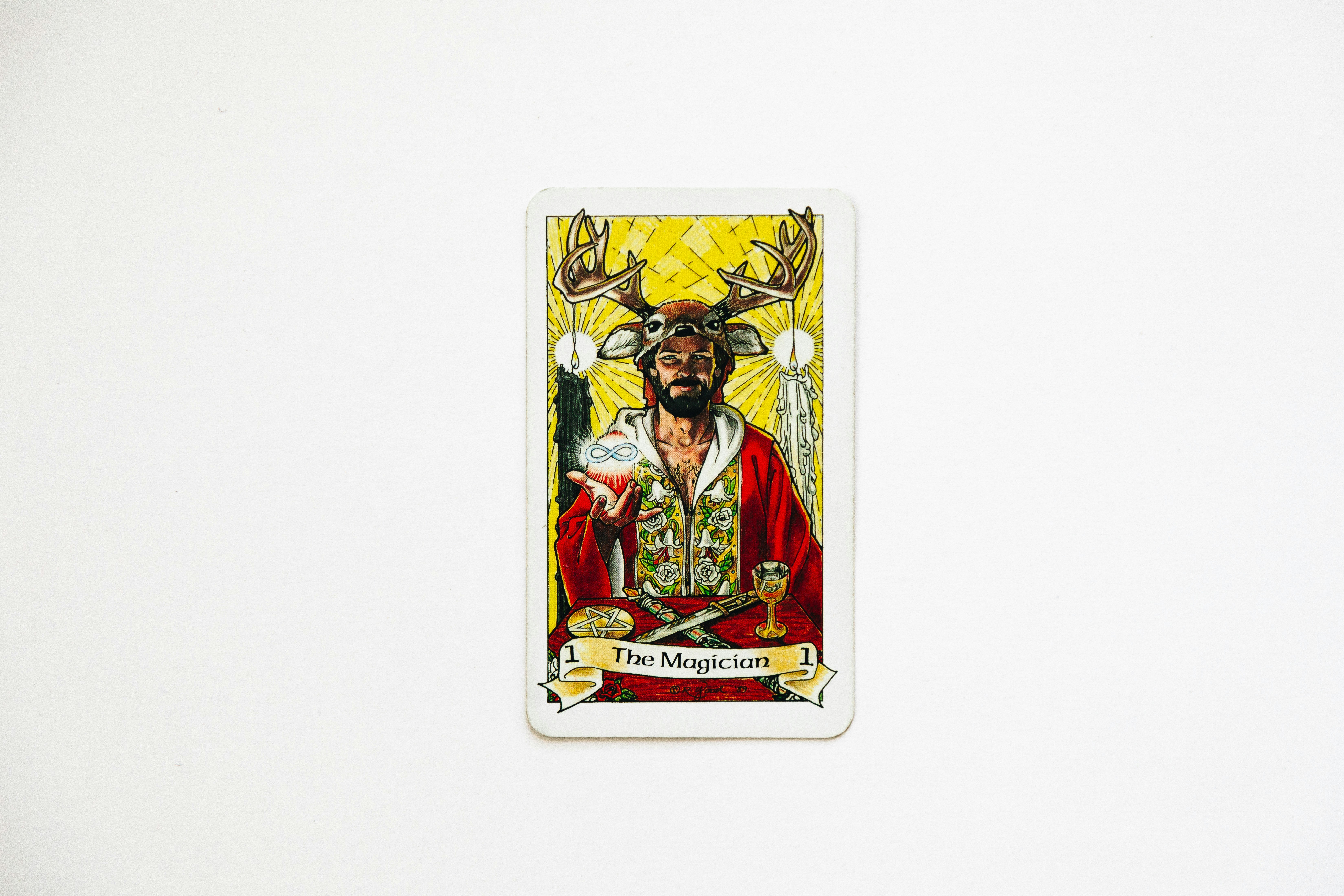 A tarot card featuring a man with antlers
