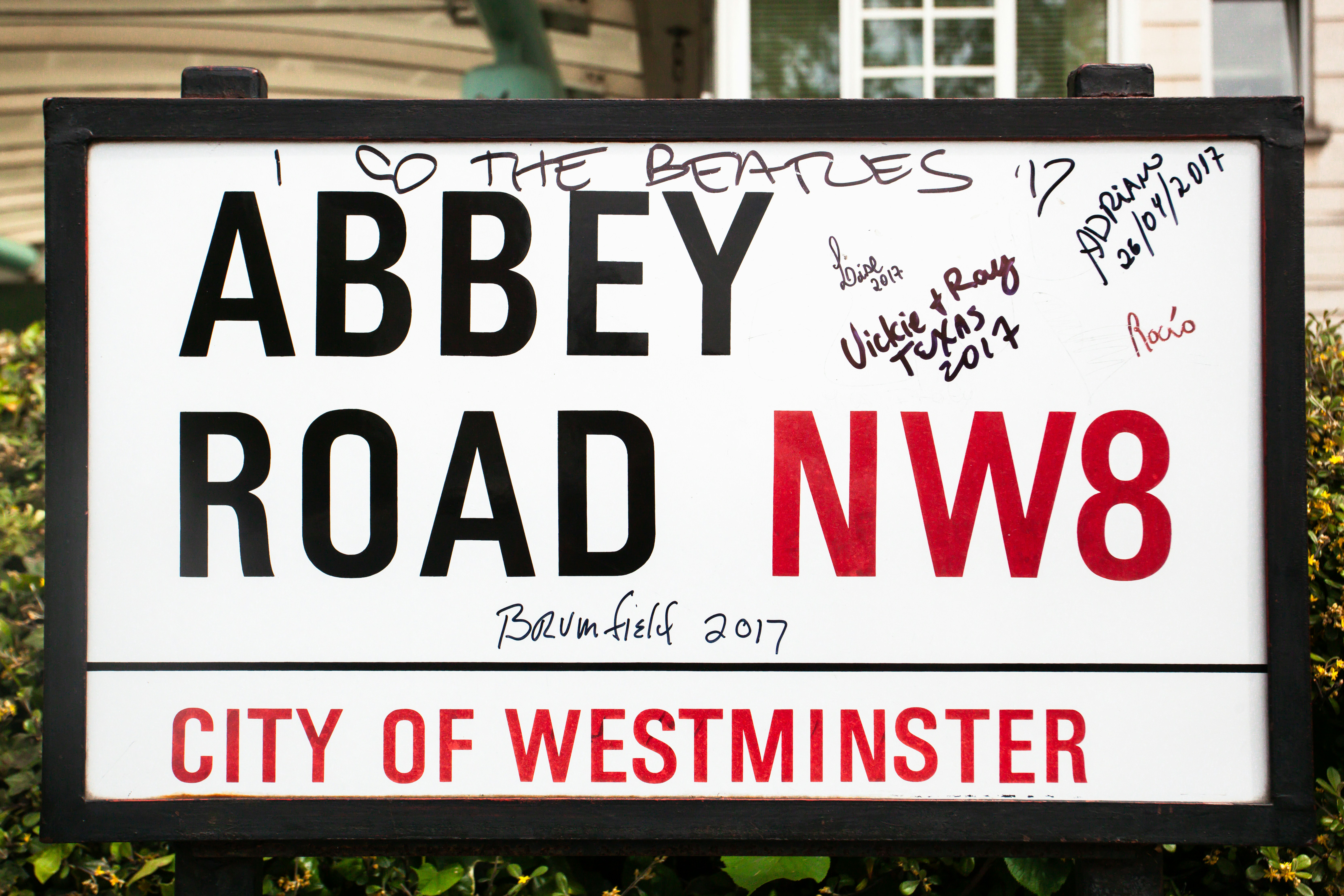 Abbey road street sign with graffiti and signatures