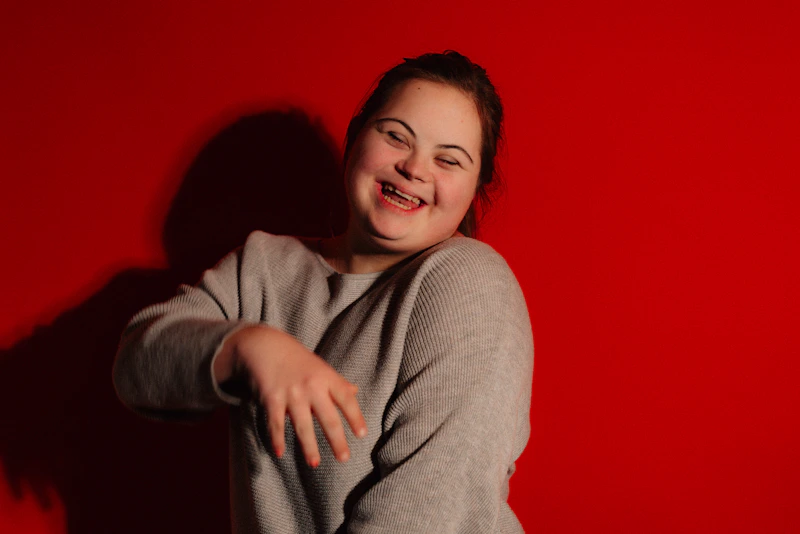 Joyful BBW woman with Down syndrome laughing