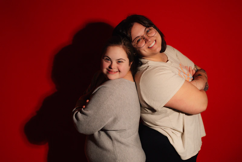 Two smiling BBW women with arms crossed