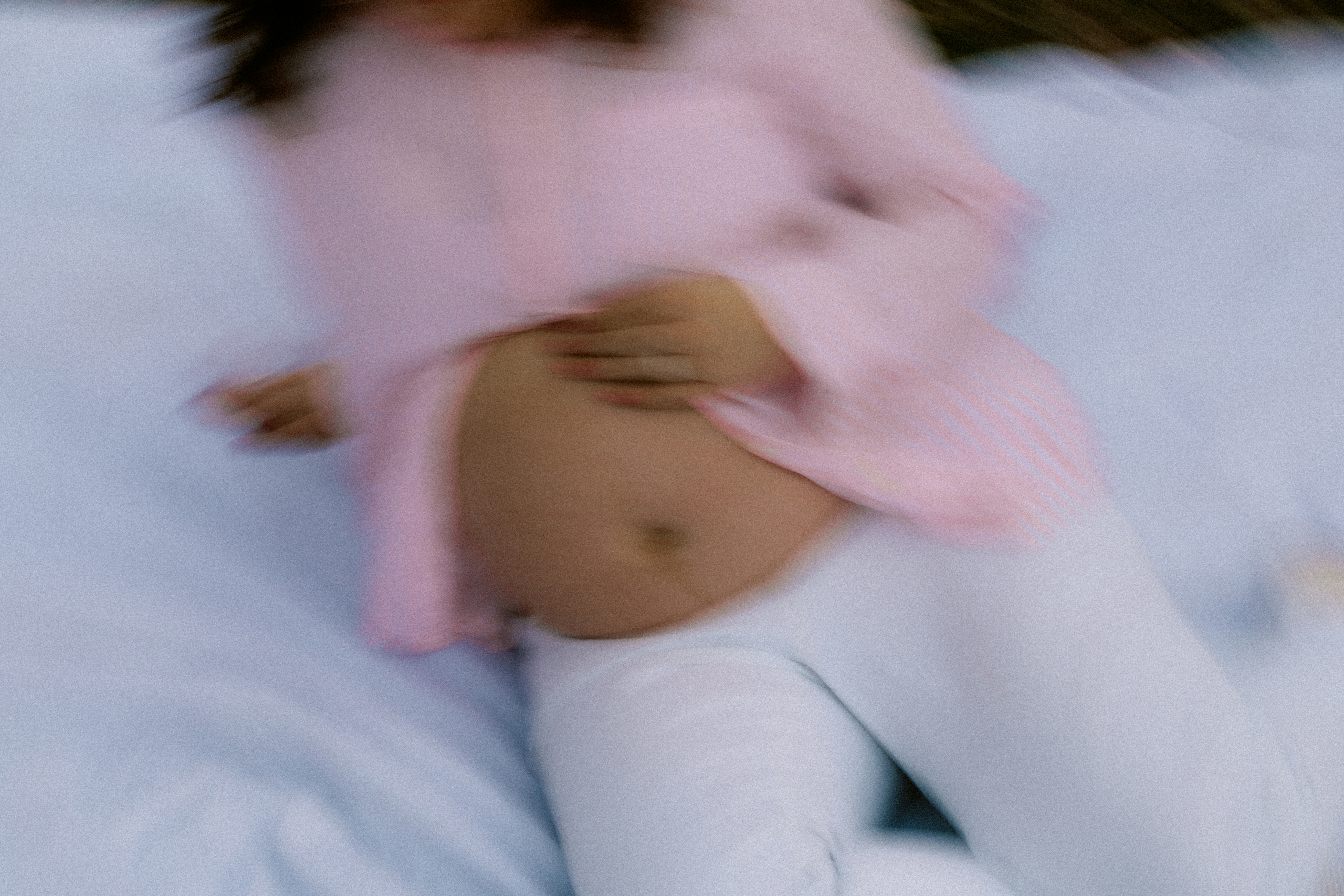 Pregnant woman in pink shirt and white pants