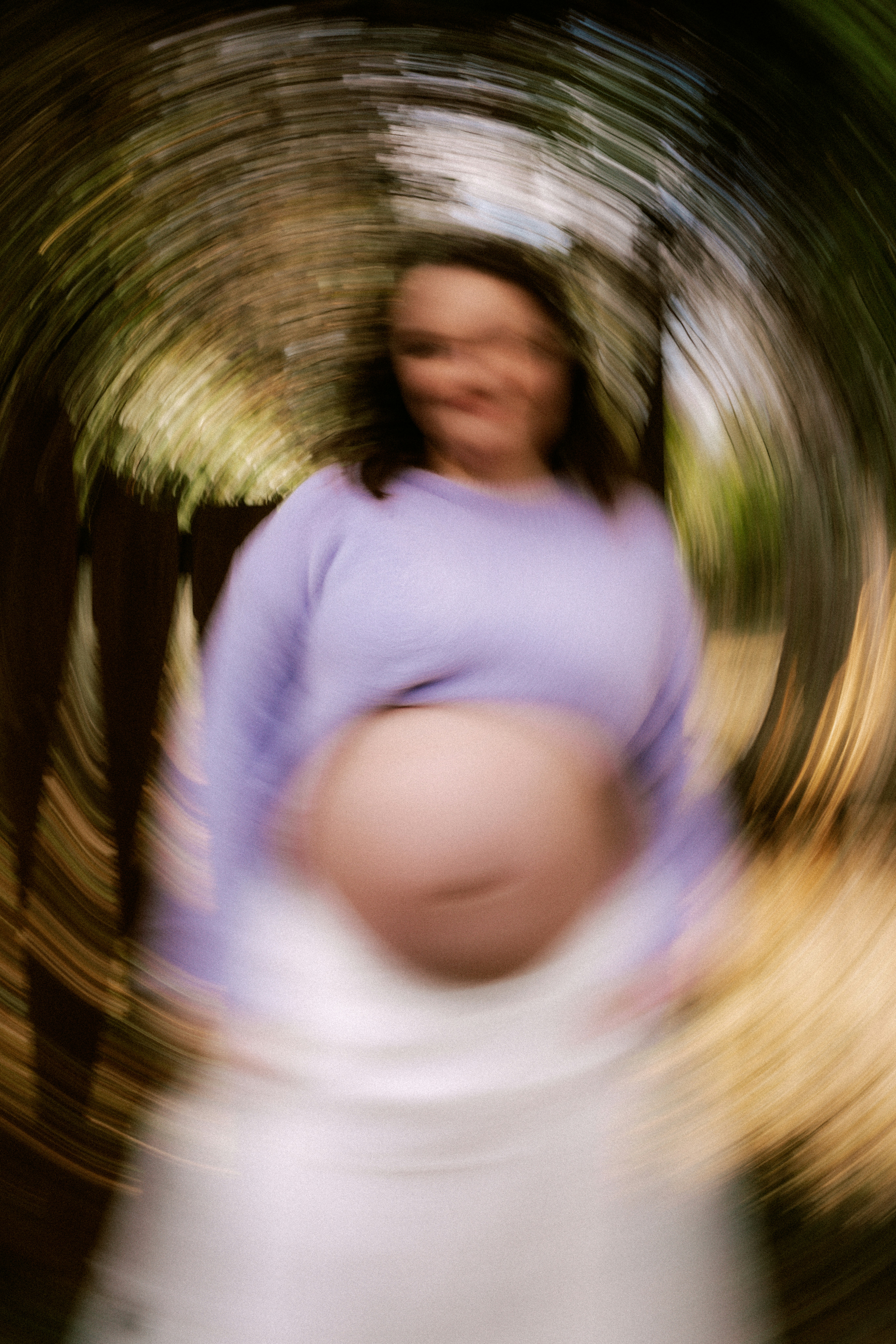 Pregnant woman with a large belly in a park